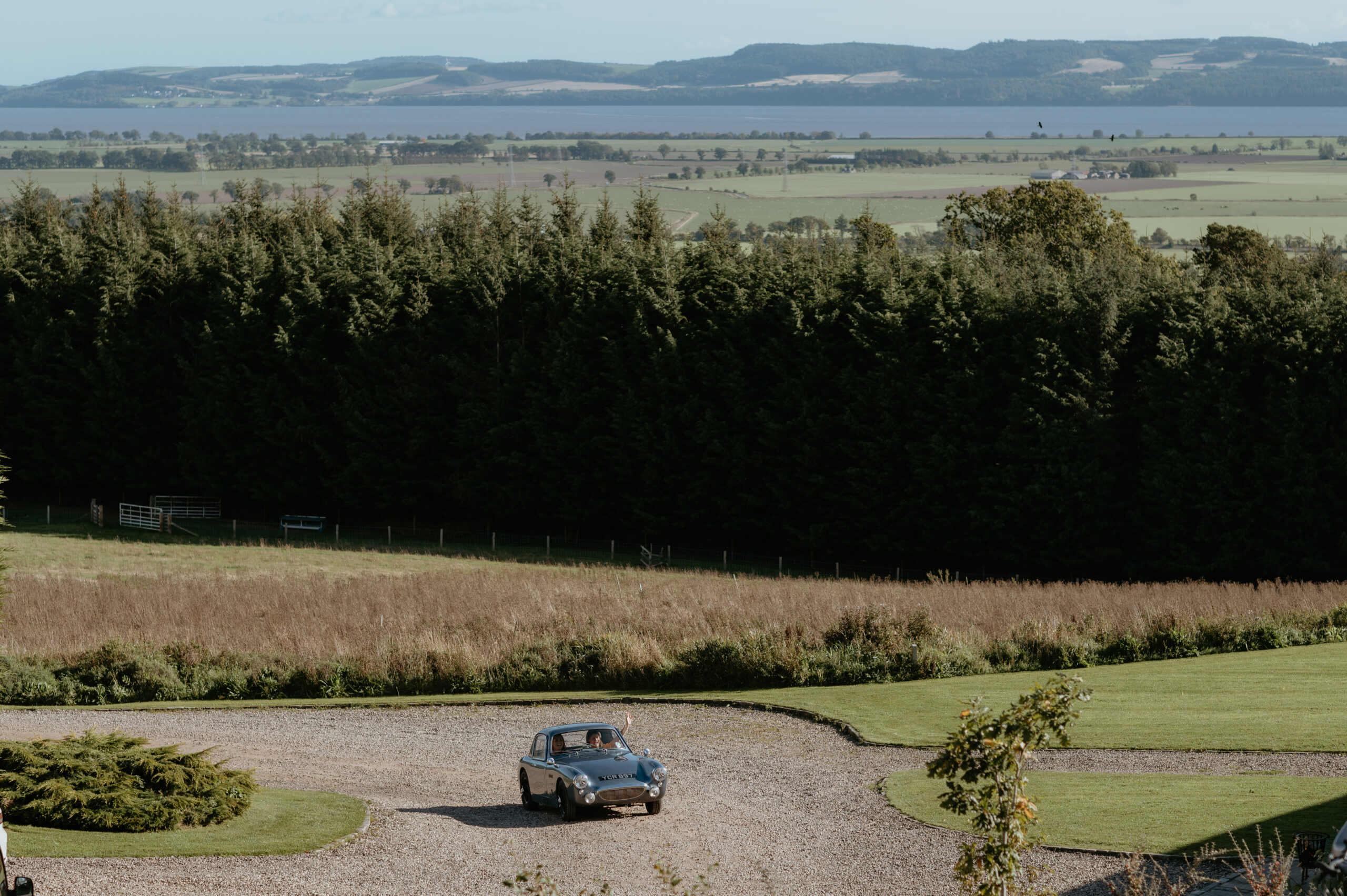 A classic car drives up to Guardswell Farm