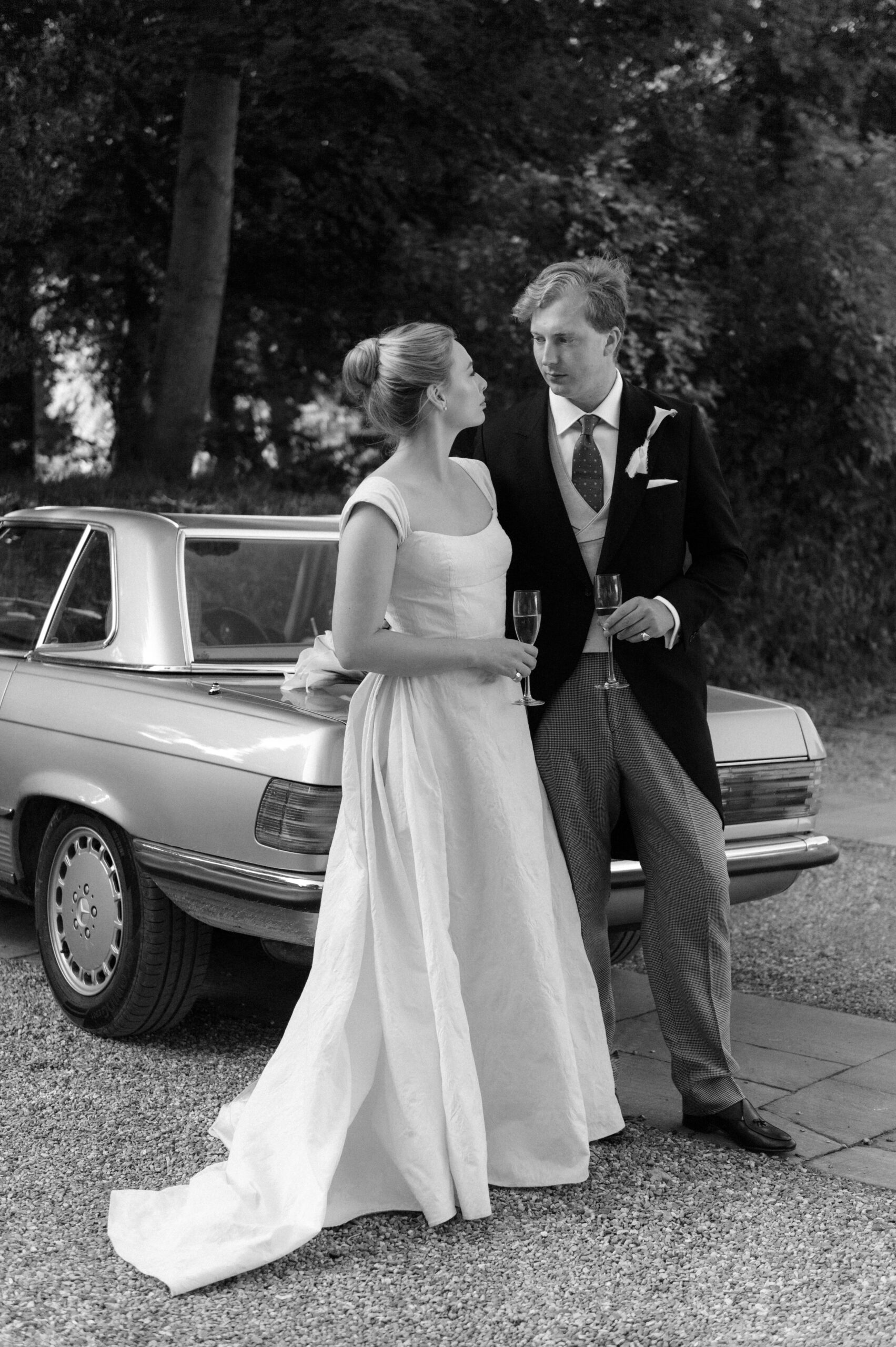 bride and groom with classic car